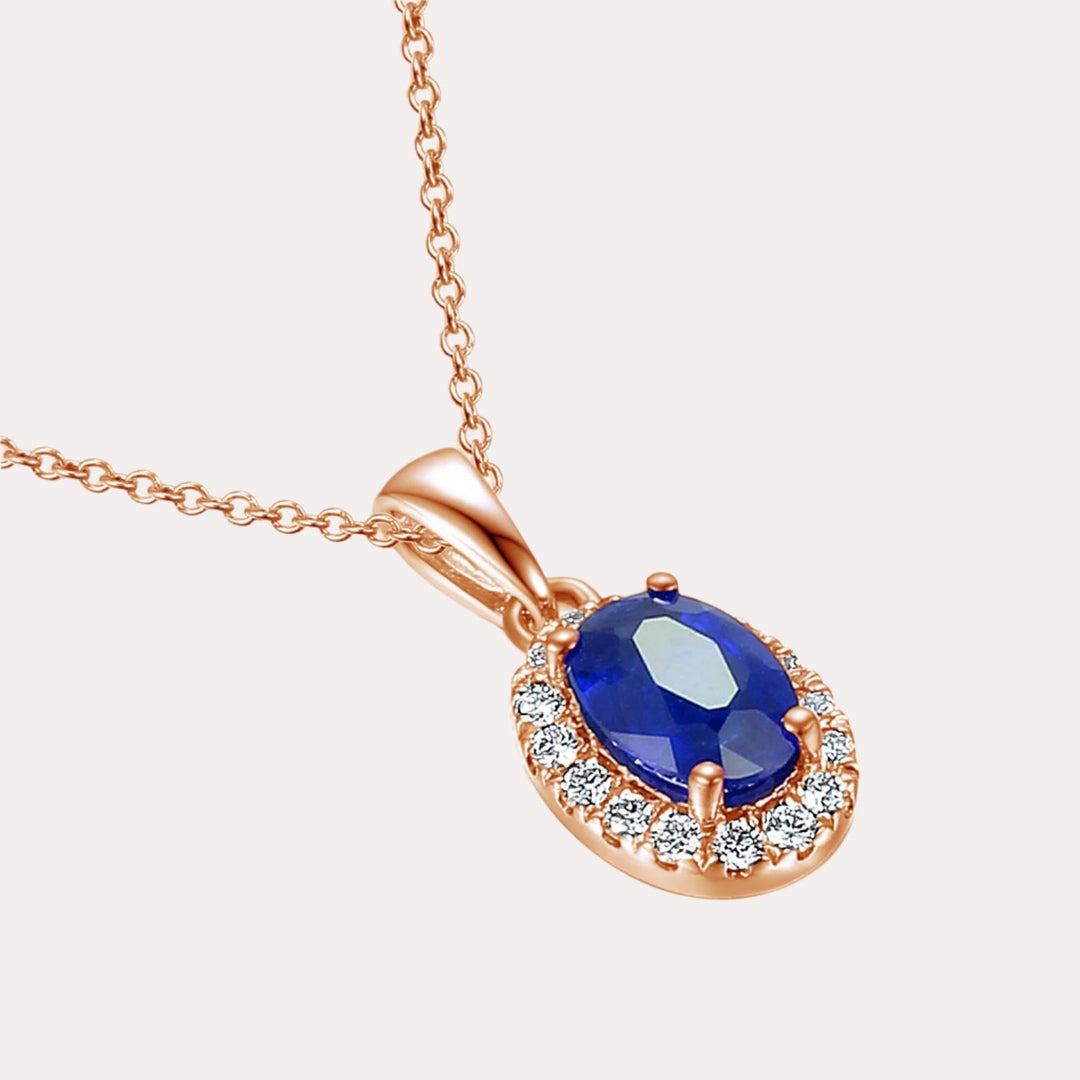 Oval Blue Sapphire With Claw Set Diamond Halo Pendant Necklace In 18K Gold - The Jewelyst. - Oval Blue Sapphire With Claw Set Diamond Halo Pendant Necklace In 18K Gold