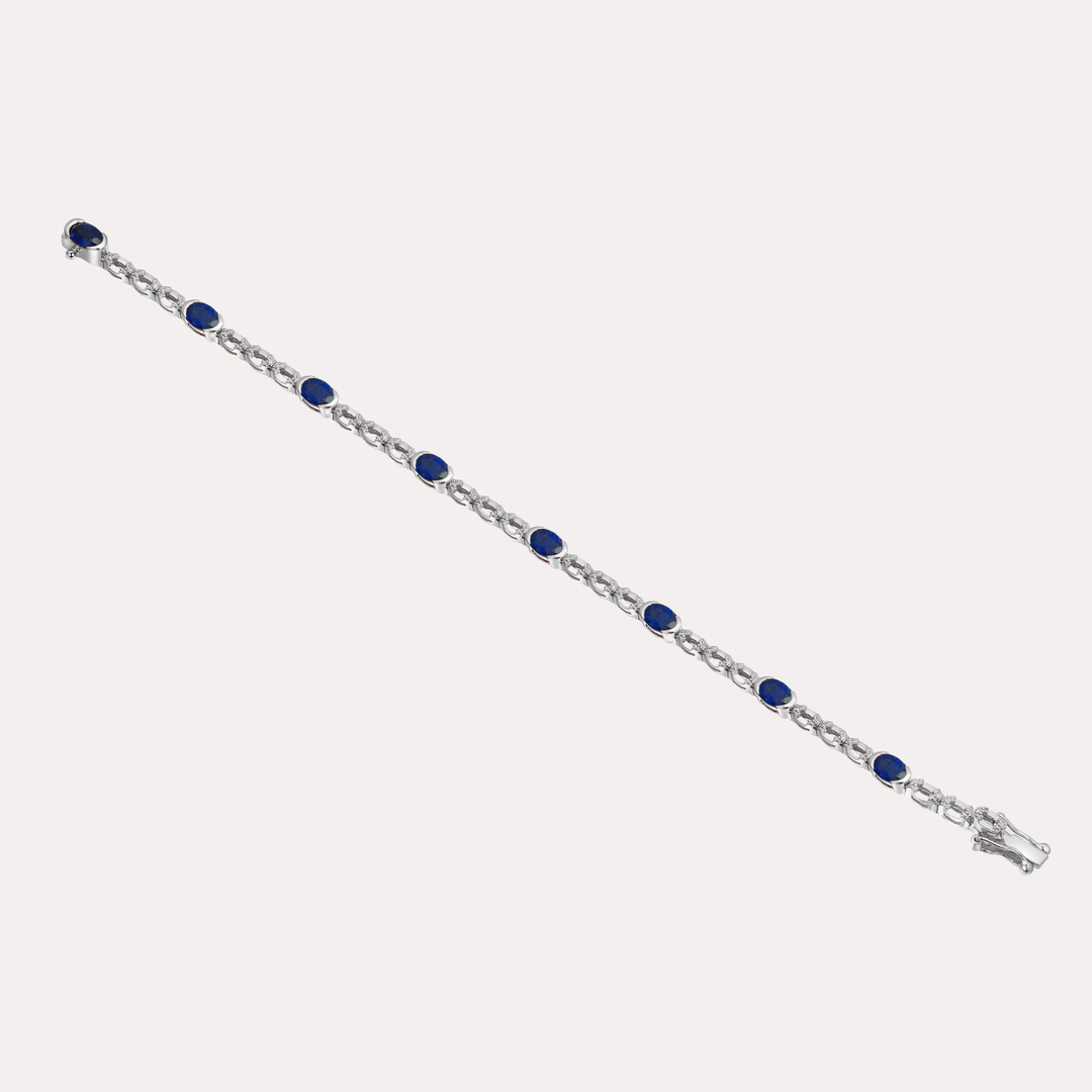 Oval Cut Blue Sapphire Rubover Set Tennis Bracelet In 18K Gold - The Jewelyst. - Oval Cut Blue Sapphire Rubover Set Tennis Bracelet In 18K Gold
