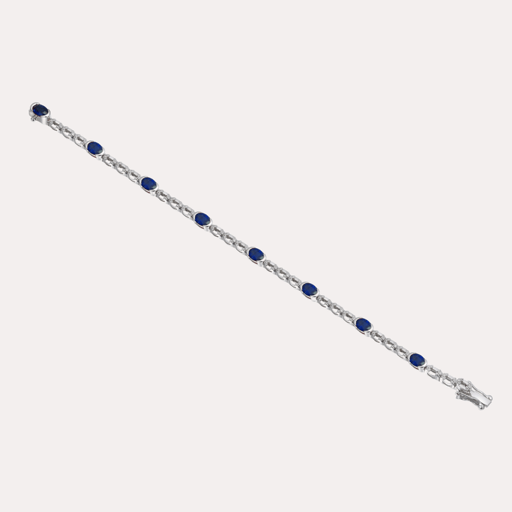 Oval Cut Blue Sapphire Rubover Set Tennis Bracelet In 18K Gold - The Jewelyst. - Oval Cut Blue Sapphire Rubover Set Tennis Bracelet In 18K Gold