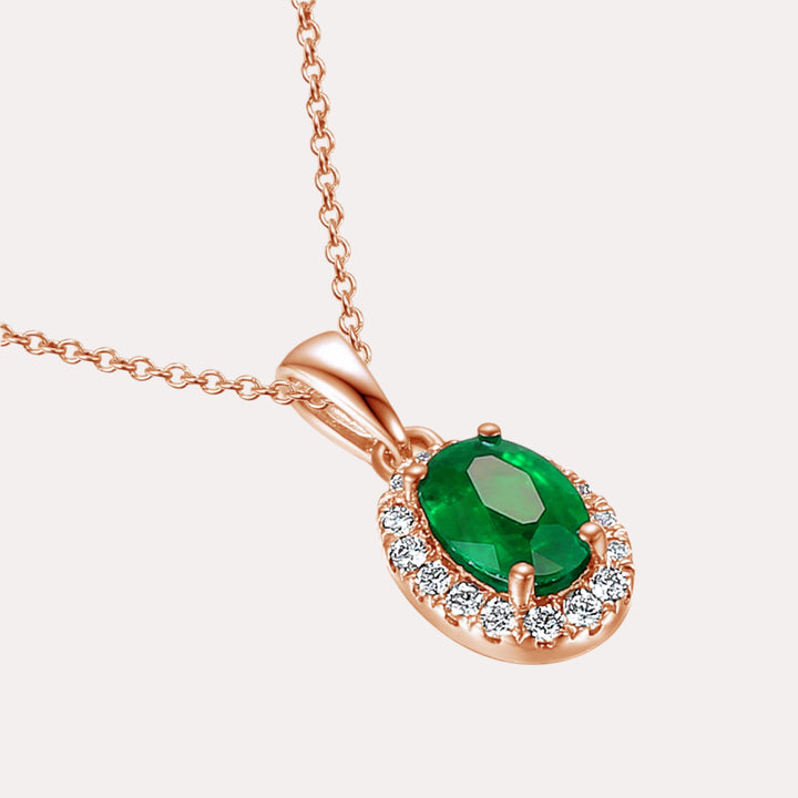 Oval Emerald With Claw Set Diamond Halo Pendant Necklace In 18K Gold