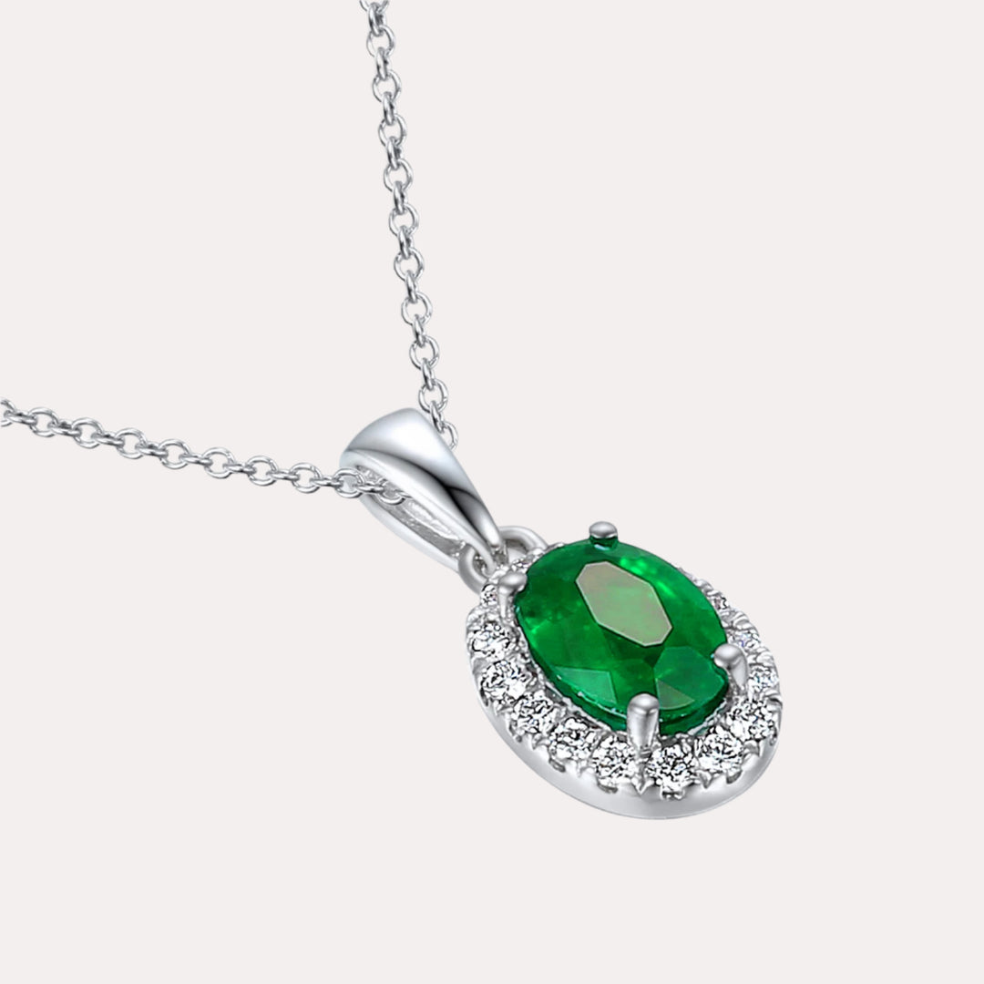Oval Emerald With Claw Set Diamond Halo Pendant Necklace In 18K Gold