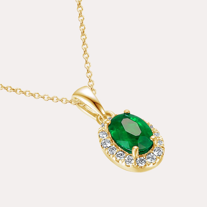 Oval Emerald With Claw Set Diamond Halo Pendant Necklace In 18K Gold