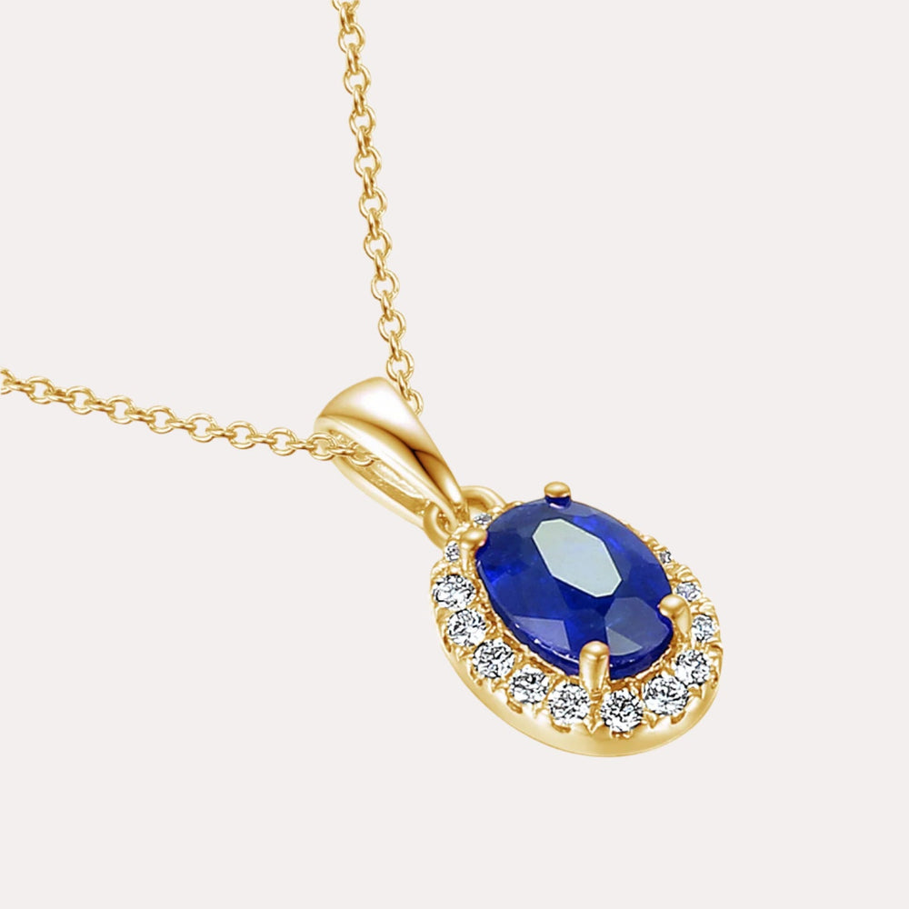 Oval Blue Sapphire With Claw Set Diamond Halo Pendant Necklace In 18K Gold - The Jewelyst. - Oval Blue Sapphire With Claw Set Diamond Halo Pendant Necklace In 18K Gold