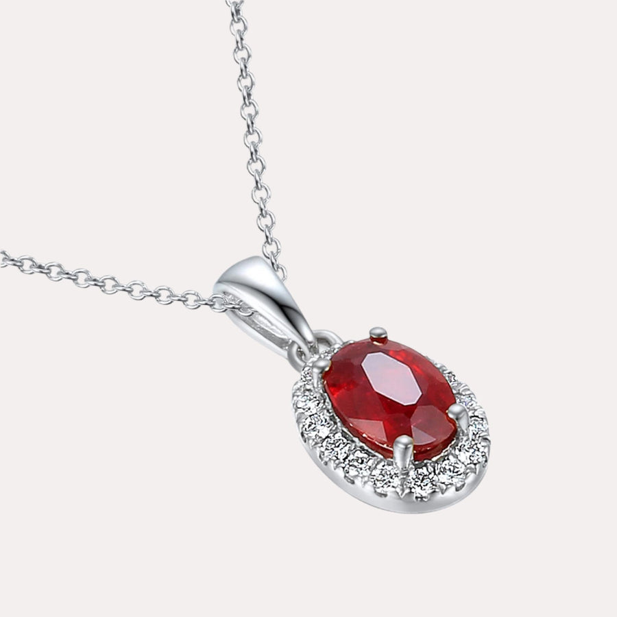 Oval Ruby With Claw Set Diamond Halo Pendant Necklace In 18K Gold - The Jewelyst. - Oval Ruby With Claw Set Diamond Halo Pendant Necklace In 18K Gold